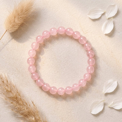 A pink rose quartz beaded bracelet specifically used for heart chakra balancing and emotional healing.