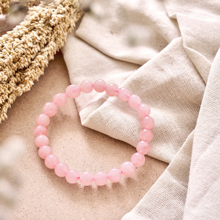 A natural rose quartz bracelet featuring soft pink gemstone beads for promoting love and emotional harmony.