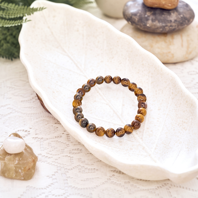A natural tiger eye bracelet featuring high-quality brown and gold beads for increased courage and confidence.