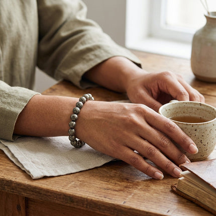 Close-up of the natural pyrite nuggets on a stretch bracelet designed for professional success and willpower.