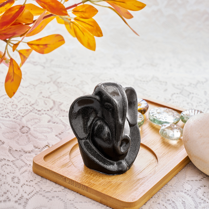 Side profile of the golden-toned pyrite Ganesha sculpture showcasing the natural mineral inclusions.