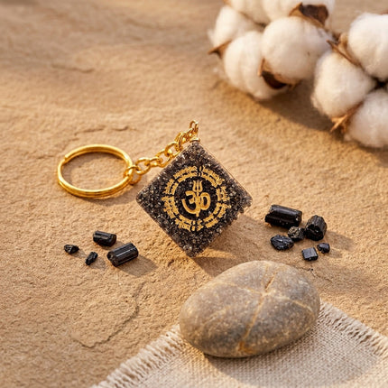 A natural pyrite OM keychain designed to attract wealth and financial abundance.