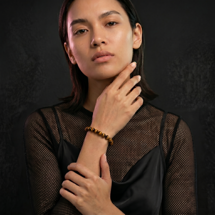 Natural tiger eye healing stone bracelet designed for use during meditation to enhance focus and solar plexus chakra healing.