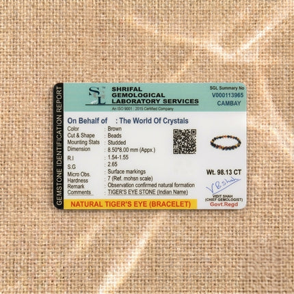 Gemstone identification report from Shrifal Gemological Laboratory for a Natural Tiger's Eye bracelet by The World Of Crystals, confirming natural formation and a weight of 98.13 CT.