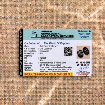 Shrifal Gemological Laboratory report for a set of two Natural Zibu and Grabovoi Wealth Coins by The World Of Crystals, verifying natural stone formation, dark green to blackish color, and a total weight of 18.92 GMS