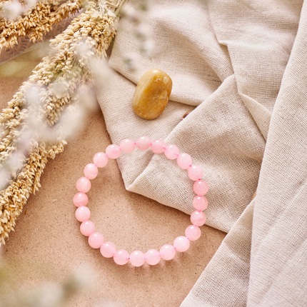 Using a rose quartz gemstone bracelet during meditation to attract positive energy and compassion.