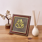 A handcrafted wooden frame featuring Lord Ganesha artwork made with natural pyrite dust for luck and prosperity.