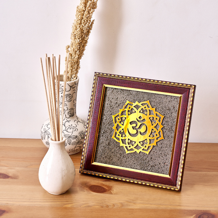 A natural pyrite dust OM symbol in a wooden frame designed to attract wealth and positive Vastu energy.
