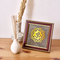 A natural pyrite dust OM symbol in a wooden frame designed to attract wealth and positive Vastu energy.
