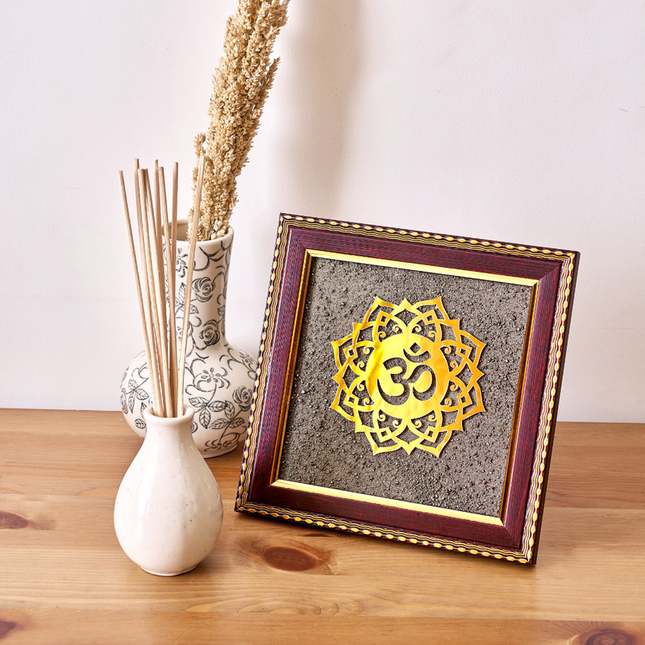 A natural pyrite dust OM symbol in a wooden frame designed to attract wealth and positive Vastu energy.
