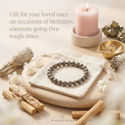 Raw Pyrite wealth bracelet displayed on a white drawstring pouch with a gifting card, highlighted as a perfect gift for manifesting financial miracles