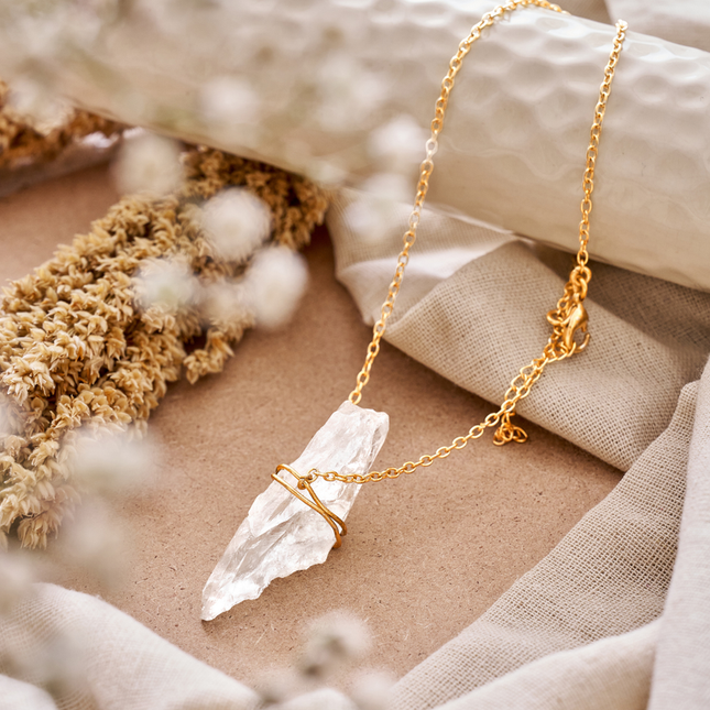 Clear quartz crystal necklace used as a healing energy amplifier for focus, balance, and positivity