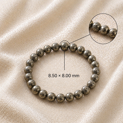 Close-up technical view of the Raw Pyrite bracelet showing the authentic golden unpolished stone sizes against a soft linen background