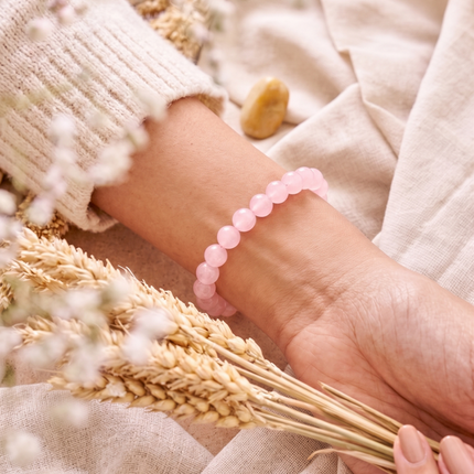 Macro view of the natural inclusions and semi-transparent pink texture of high-quality rose quartz beads.