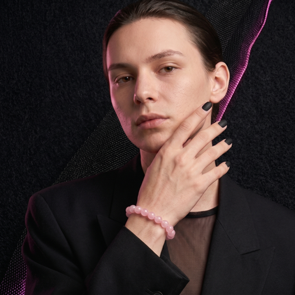 Close-up of the flexible stretch cord on a rose quartz bracelet ensuring a comfortable fit for all wrist sizes.