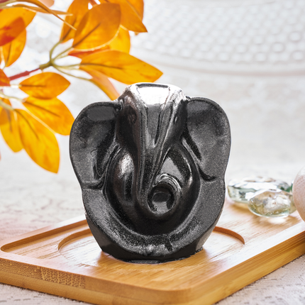 Close-up showing the metallic luster and intricate carving details of the natural pyrite Ganesha statue.